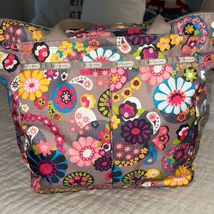 Lesportsac Floral Tote . Zip top . Inside pockets. .